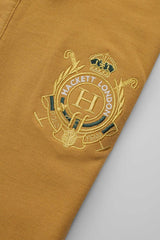 Hackt Lndn Heritage Crown Graphic Men's Polo Shirt In Mustard